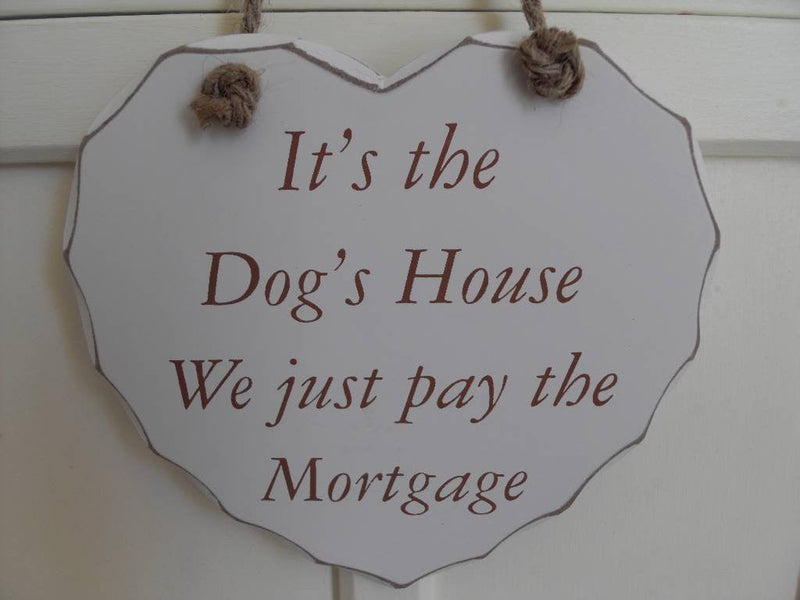 its the dogs house hear plaque we just pay the mortgage