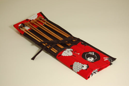 Knitting pins - 8 prs bamboo knitting needles in red fabric case showing black and white cartoon sheep